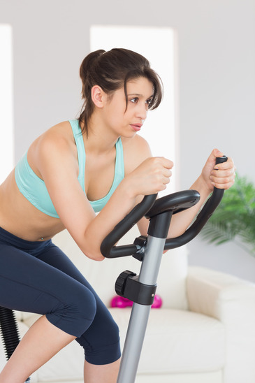 Bored looking woman on an exercise bike