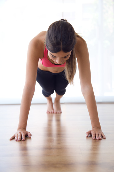 Young Woman Doing A HIIT Workout At Home