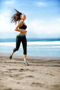 Woman Running On Beach