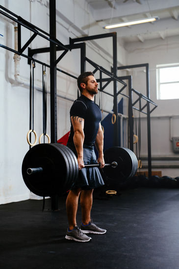 Man Lifting Barbells At A Bodybuilding Gym
