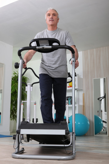 Middle Aged Man On Treadmill At Home