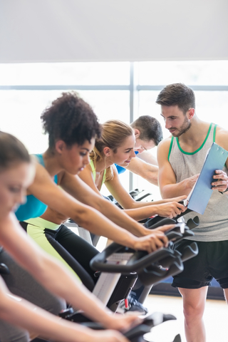 Instructor Giving Advice In A Group Cycling Class