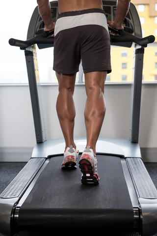 Fit Man Running On Treadmill