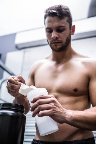 Muscular Man Preparing Protein Shake