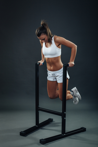 young woman using a dip stand